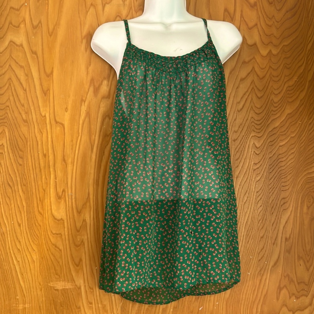 Sheer green tank top with bows pattern. See through